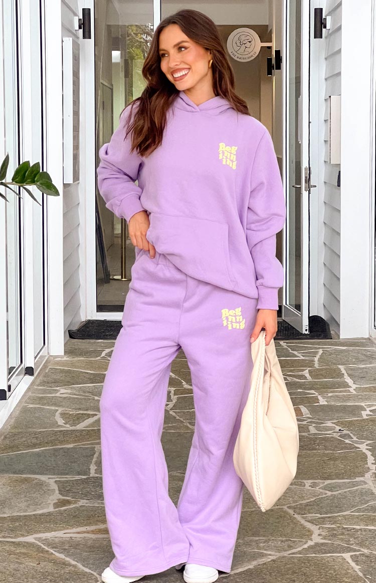 Purple wide-leg track pants with a yellow 'Beginning' logo on the left thigh