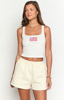 Model wearing cream coloured sweat shorts with a red embroidered American dream graphic across the back