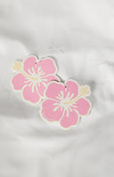 Girl in a car with a hanging pink flower air freshener