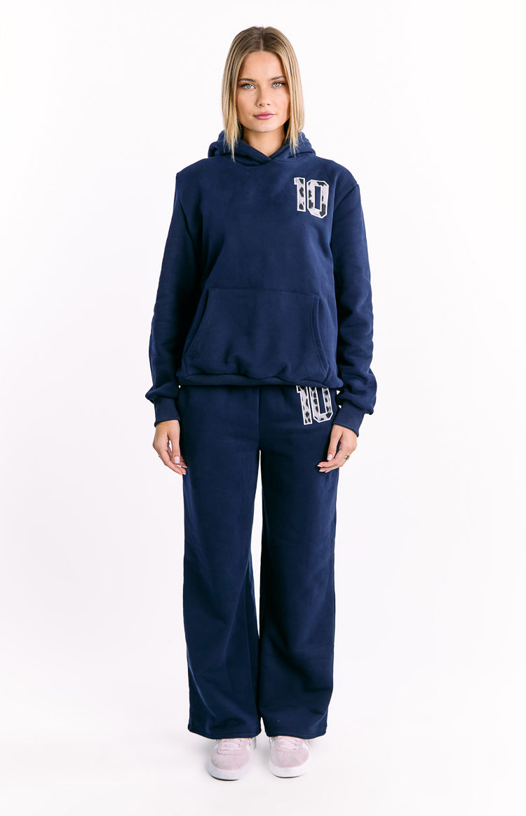 Full length view of a navy oversized hoodie with white leopard star print '10' on chest, hood, and kangaroo pocket