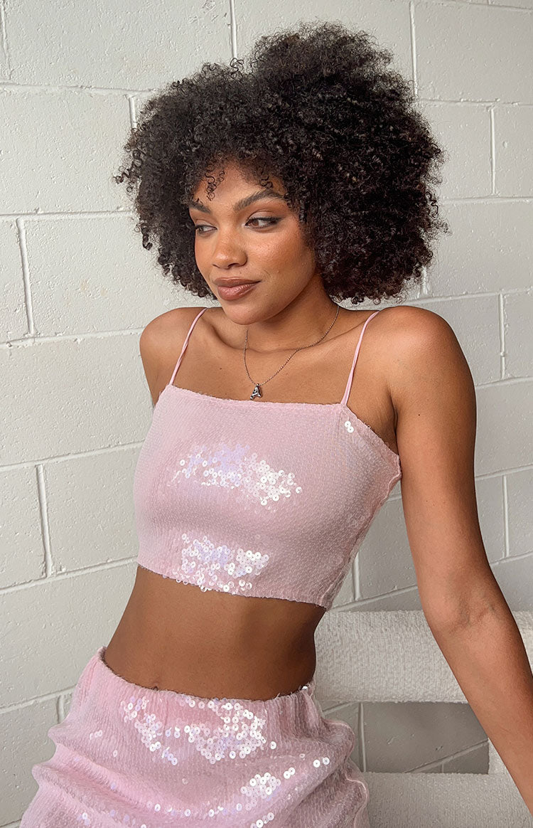 Detail shot of the light pink sequin crop top, highlighting the shimmering iridescent sequins and thin spaghetti straps
