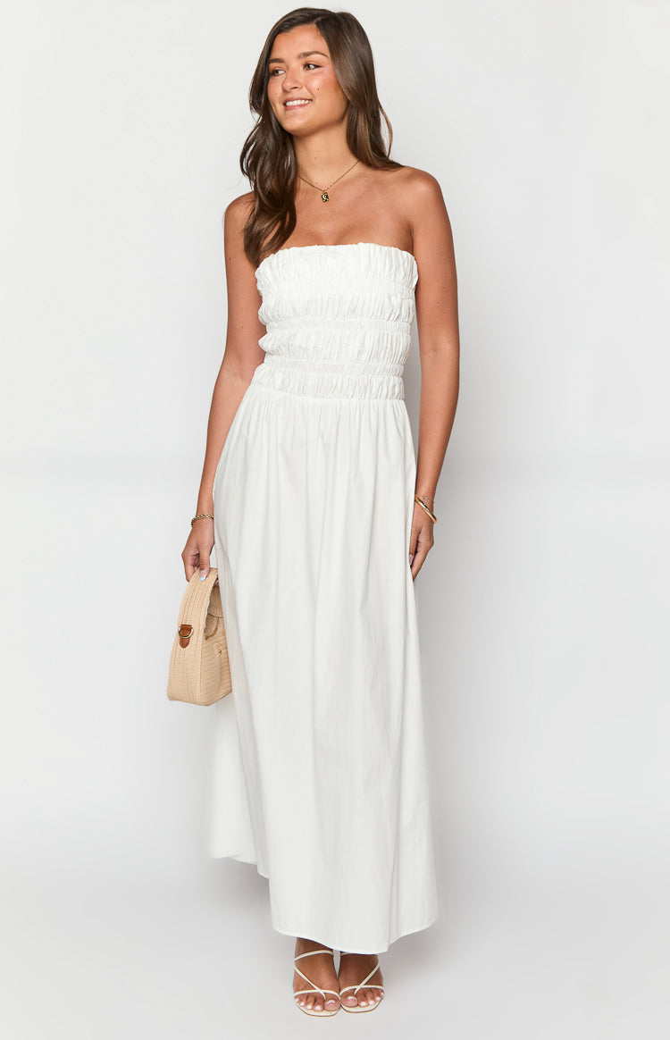 White strapless maxi dress with a shirred bodice and smocked waist flowing into a relaxed A-line skirt