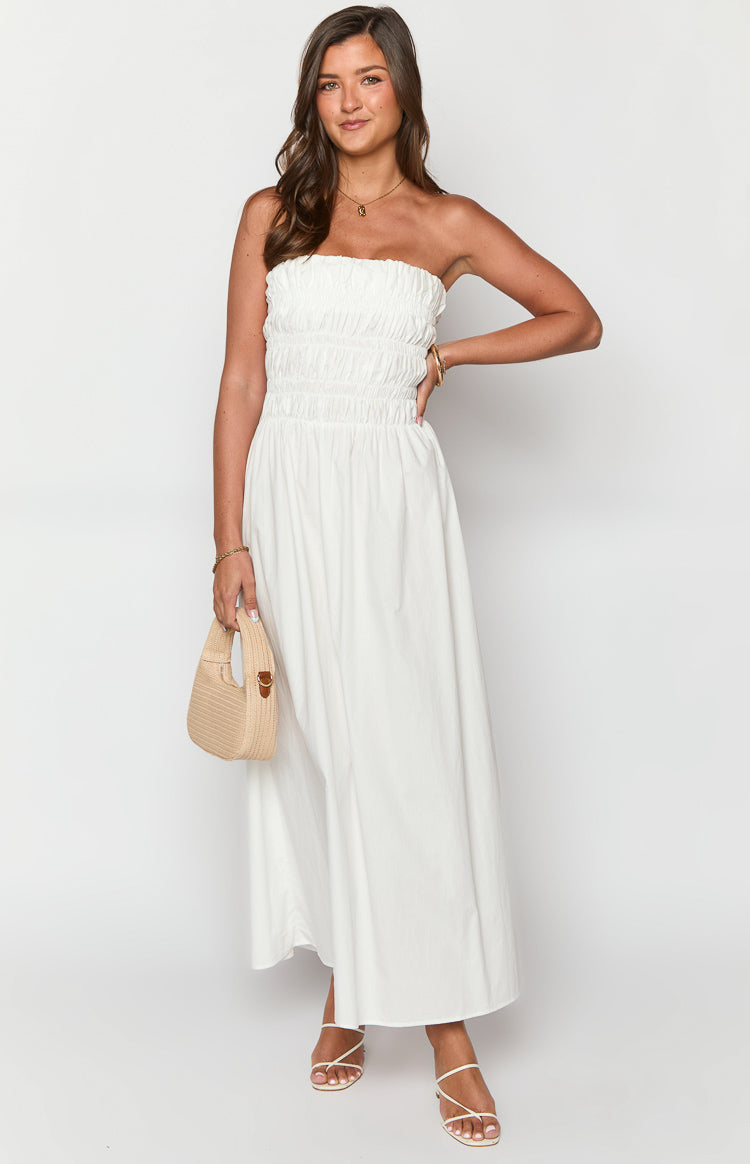 Front view of a white strapless maxi dress with a smocked bodice and a gathered flowy skirt