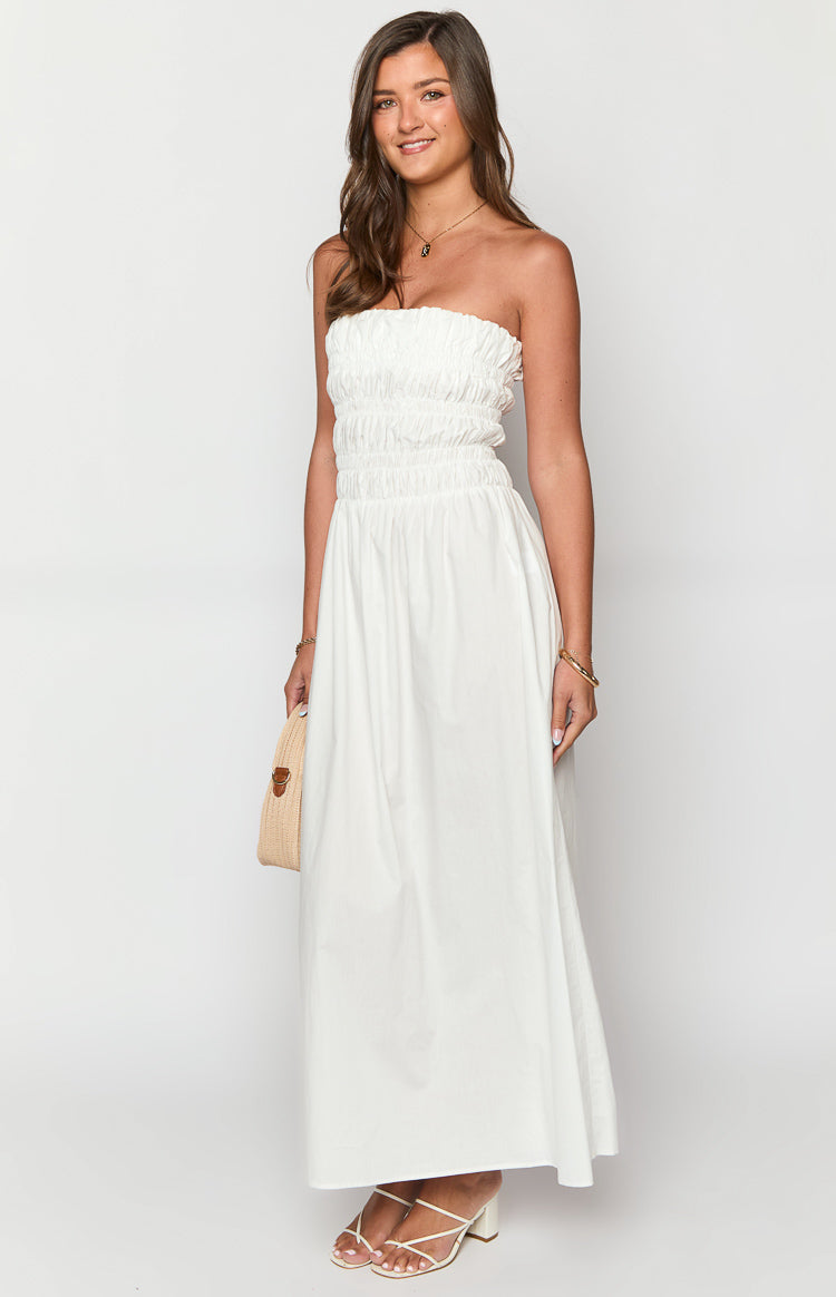 White strapless maxi dress with a shirred bust and elasticated waist, flowing into a full A-line skirt