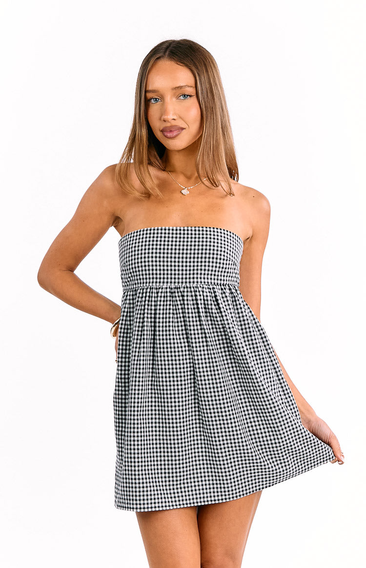 Front view of a black gingham strapless mini dress with a gathered waist and a flowy A-line skirt
