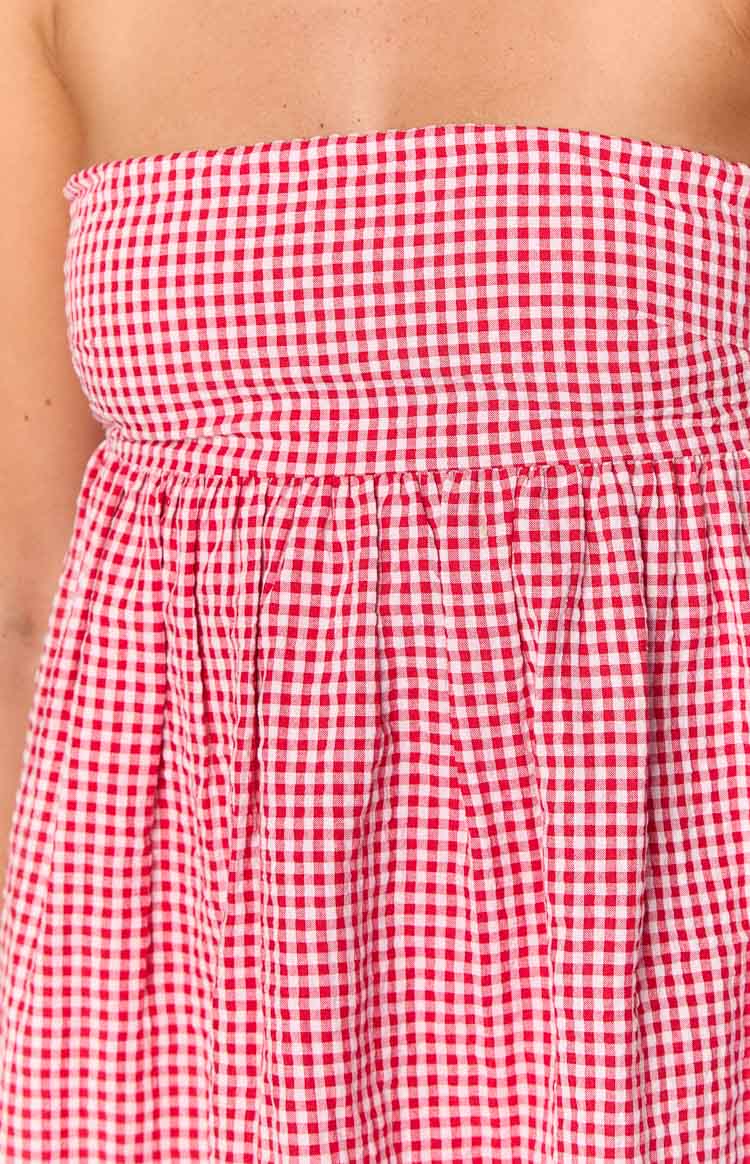 Close-up of the red gingham strapless mini dress showing the fitted bodice and gathered waist seam