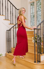 Side and rear view of a wine crepe maxi dress showing the open back with criss-cross tie straps