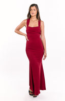 A form-fitting- mermaid-style long gown in a rich wine red- featuring a pleated and ruched strapless bustline with subtle halter-style straps. This elegant dress is suitable for a formal event or gala.