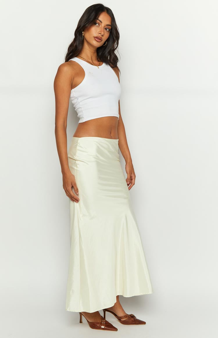 Side view of a cream satin maxi skirt with a fitted waist and a gentle flare