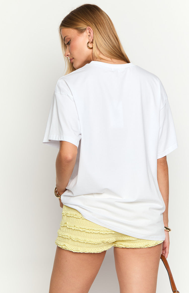 Back view of a white oversized cotton tee with short sleeves and a relaxed fit