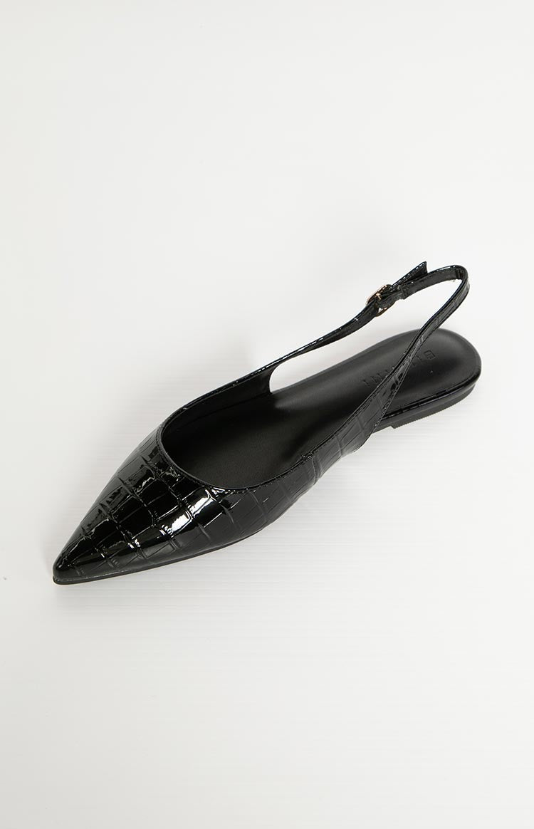 Top-down view of a black patent croc mule with a pointed toe and adjustable slingback strap