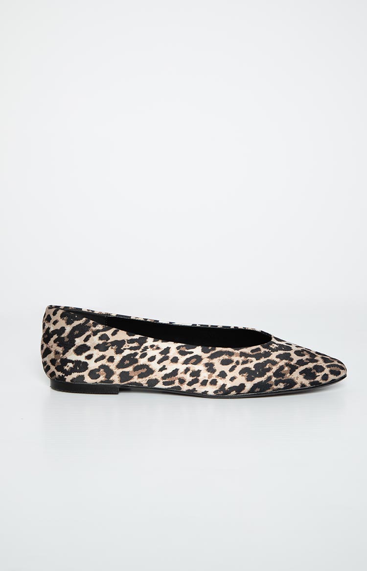 Side view of a single leopard print ballet flat with a pointed toe and low-cut vamp