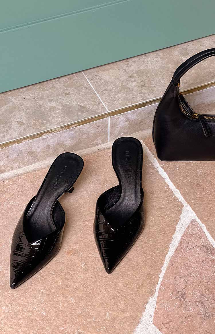pinterest style flat lay of black pointed toe kitten heels with a crocodile patent outer