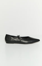 Side profile of a black leather ballet flat with a pointed toe and a small tie detail on the vamp