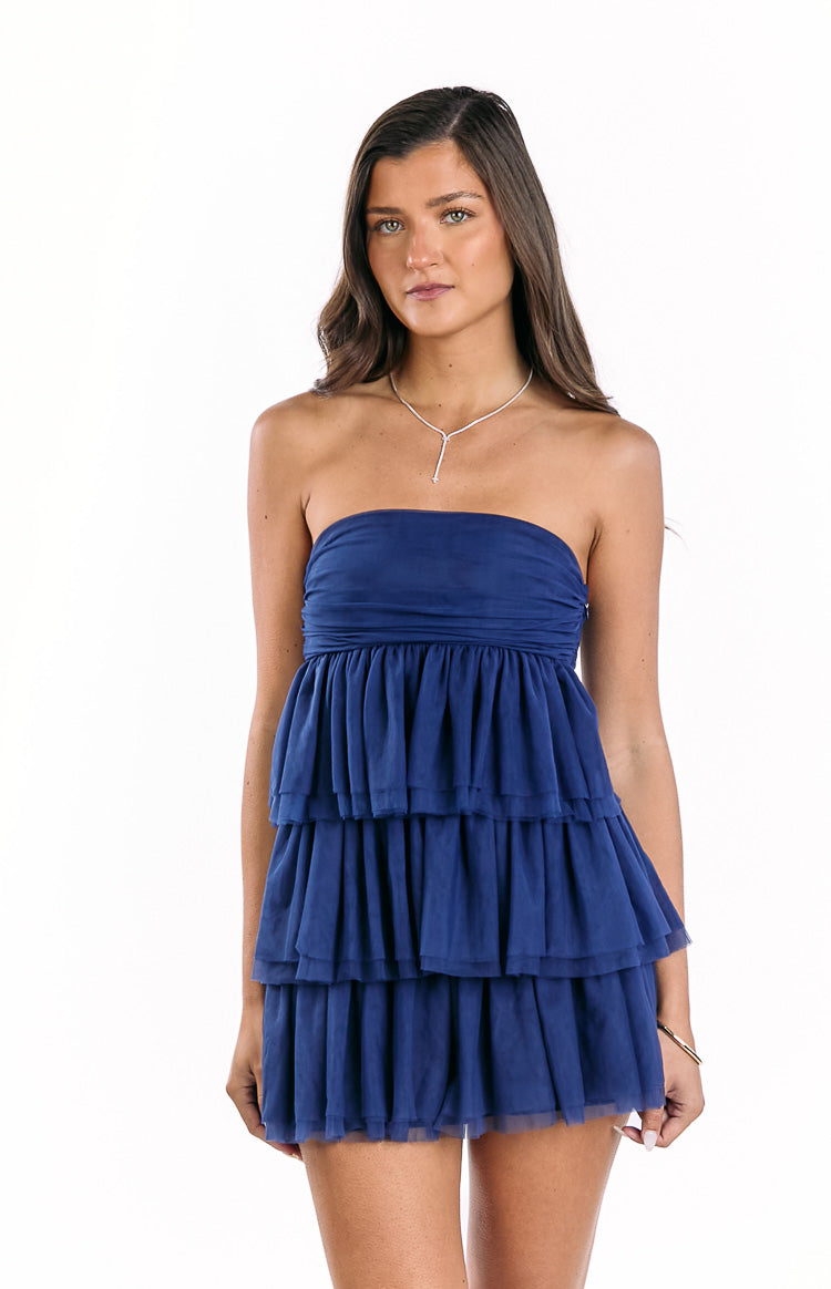 Navy strapless mini dress with a ruched bodice and three tiered ruffle skirt in sheer fabric
