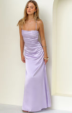 Lilac satin maxi dress with thin spaghetti straps, straight neckline, and ruched sides on the bodice