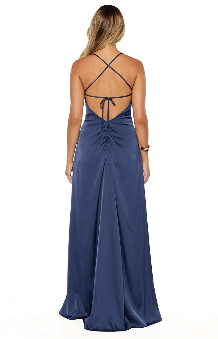 Rear view of a navy satin maxi dress with criss-cross back straps, a tie closure, and ruched detail