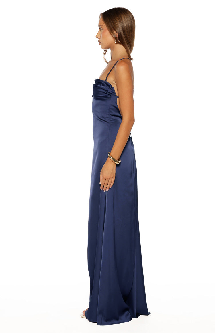 Side view of a navy satin maxi dress showing the ruched bust and flowing skirt