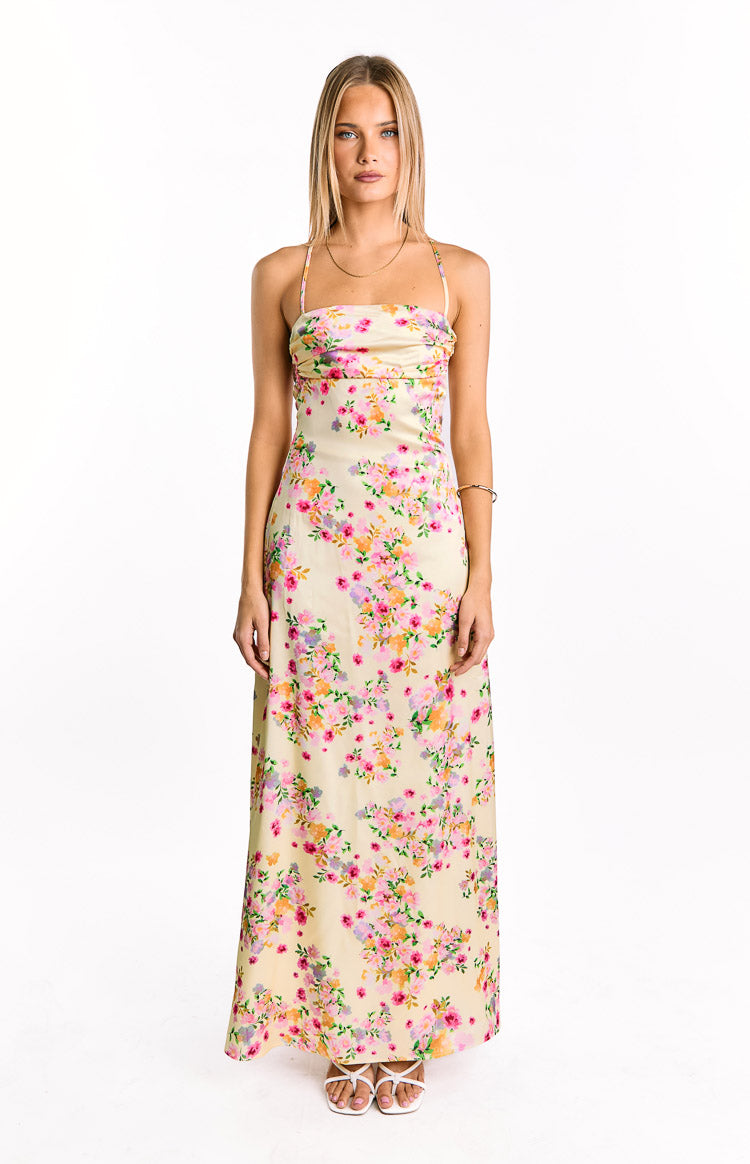 Front view of a yellow floral satin maxi dress with a gathered bandeau neckline and thin spaghetti straps