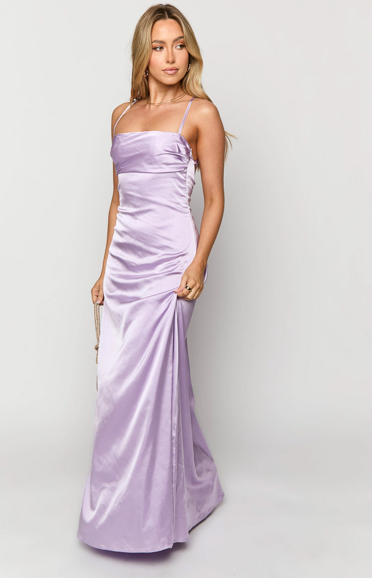 Side view of a lilac satin maxi dress, highlighting the fitted bodice with side ruching and flowing skirt