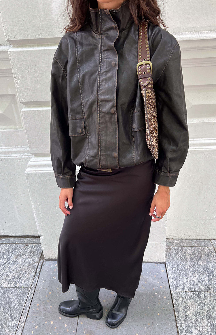 Front view of a brown funnel neck PU jacket with button-front, chest flap pockets, and a distressed finish