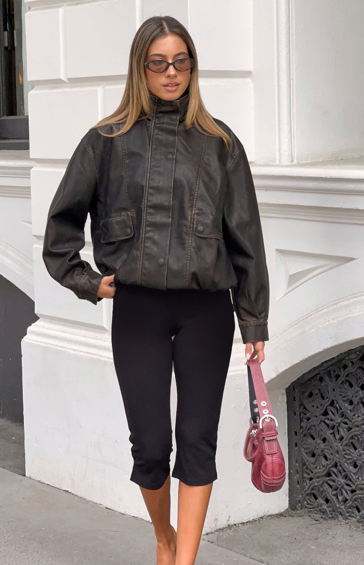 Front view of a distressed brown PU jacket with a funnel neck, button placket, and elasticated hem