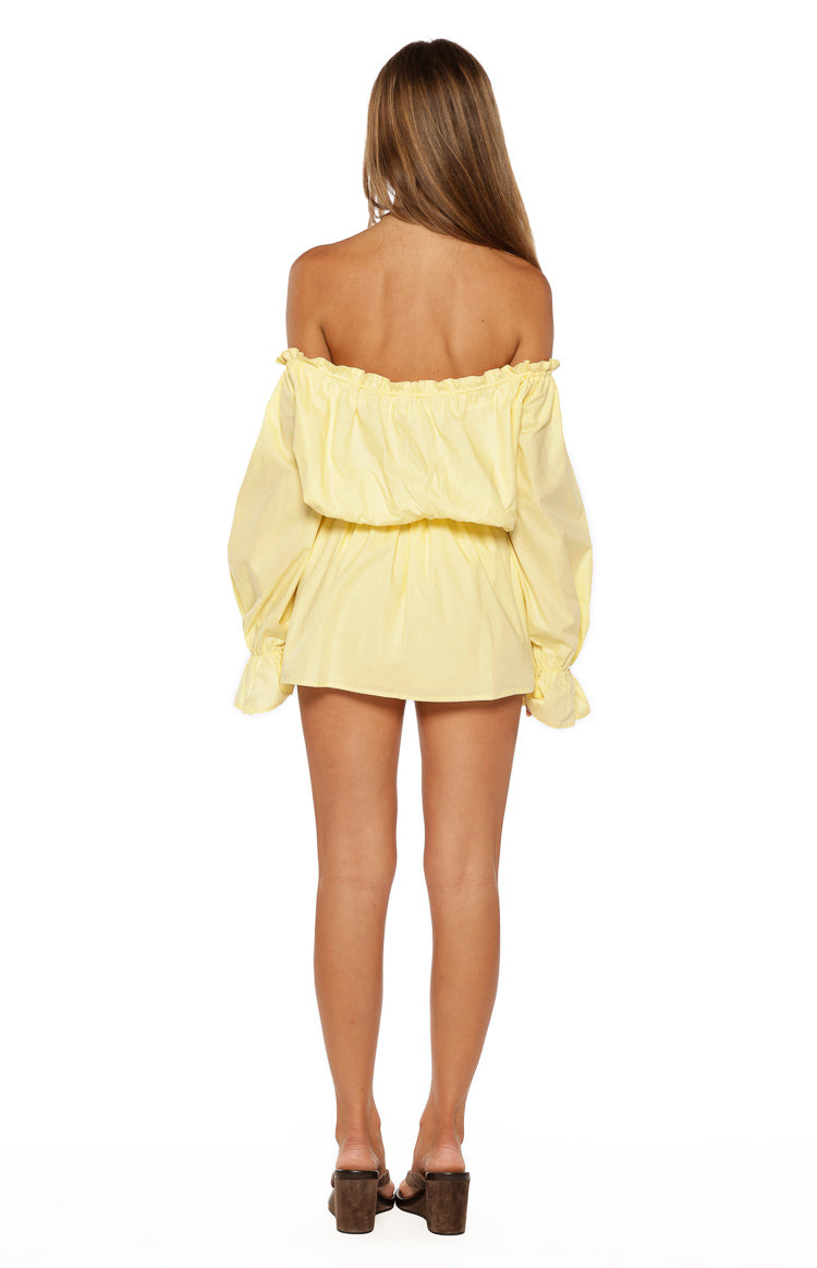 Rear view of the yellow bardot mini dress showing the ruffled off-shoulder neckline and elasticated blouson waist