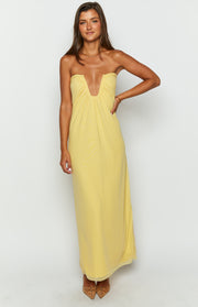 Front view of a yellow strapless maxi dress with a deep V-plunge neckline and ruched bust