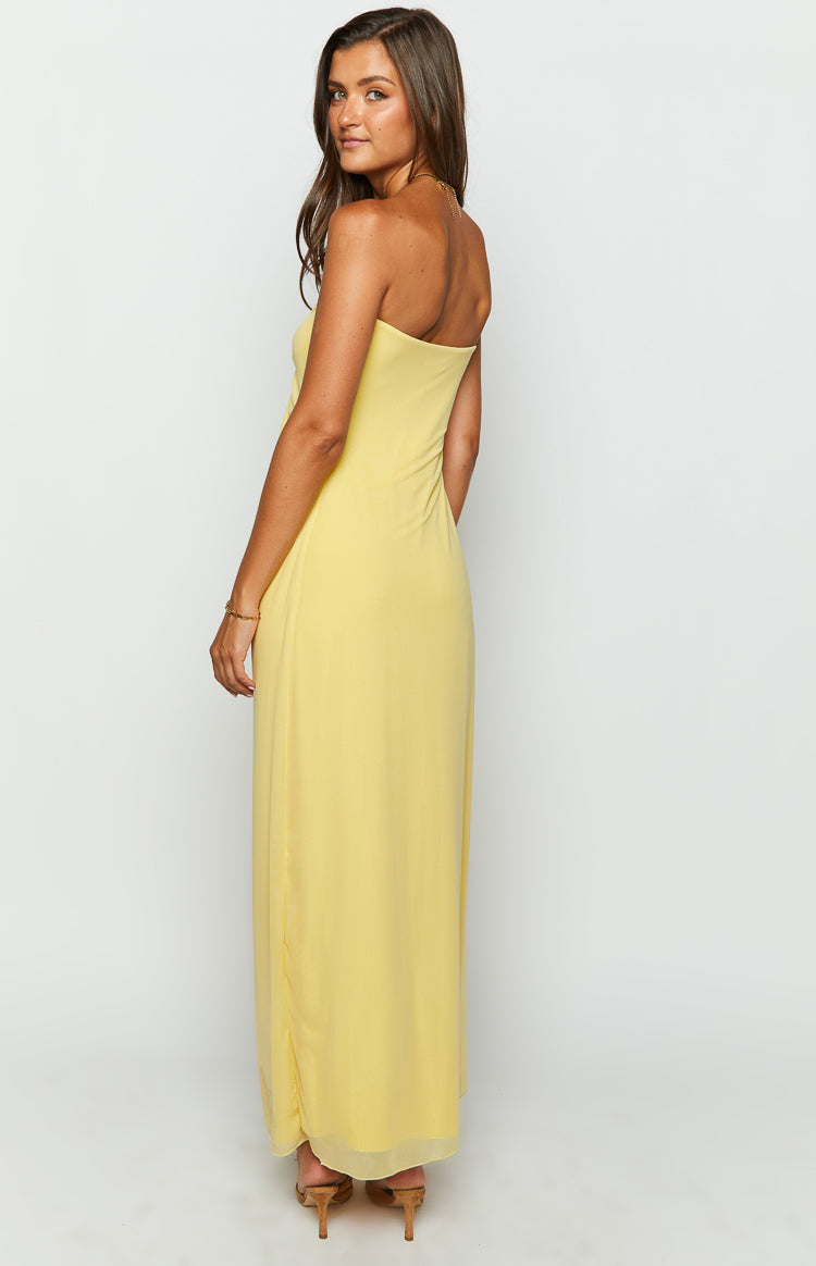 Side and back view of a light yellow strapless maxi dress with a fluid drape and a subtle sheer overlay