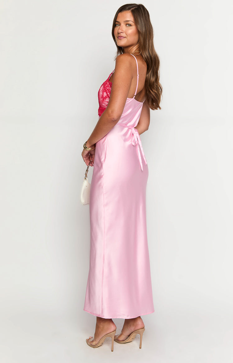 Side view of a pink satin maxi dress with a red lace bodice and a self-tie back
