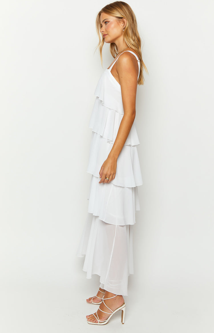 Side view of a white tiered maxi dress with spaghetti straps and a sheer bottom layer