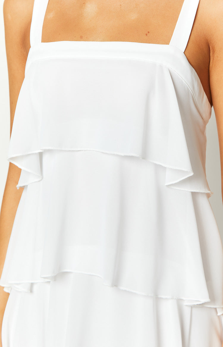 Close-up of the square neckline and white layered frills with raw edges on a maxi dress