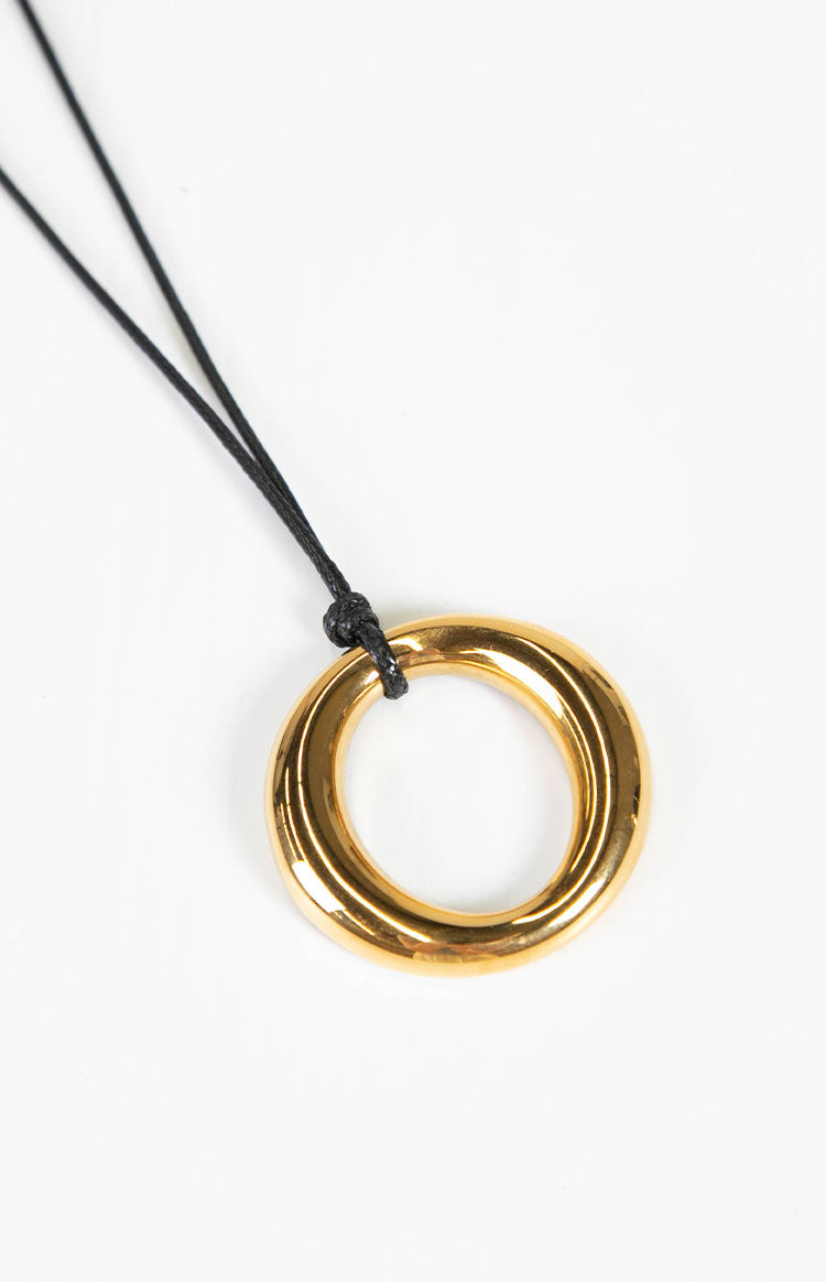 Close up view of the polished gold ring pendant a modern and elegant statement piece perfect for gifting