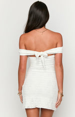 Rear view of a white lace off-the-shoulder mini dress with a tie-back detail at the upper back