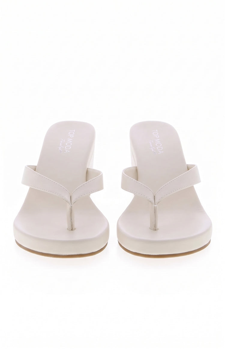 Ivory PU wedge sandals with a thong strap, wide foot band, and a comfortable platform sole