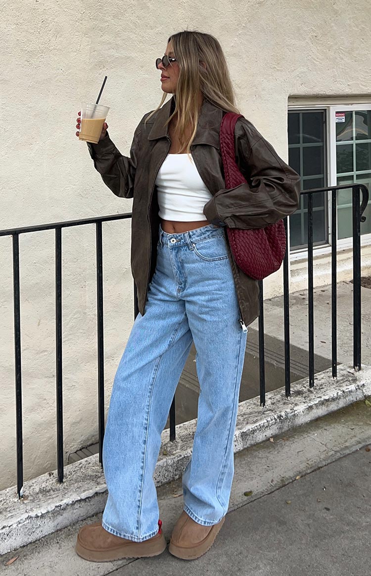 Full length view of light wash mid rise slouchy jeans with a wide leg and relaxed fit