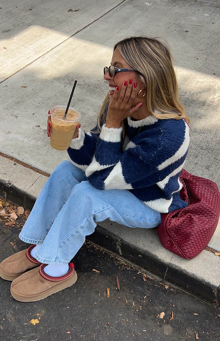 Light wash mid-rise slouchy jeans with a relaxed straight leg, showing the loose drape and relaxed fit