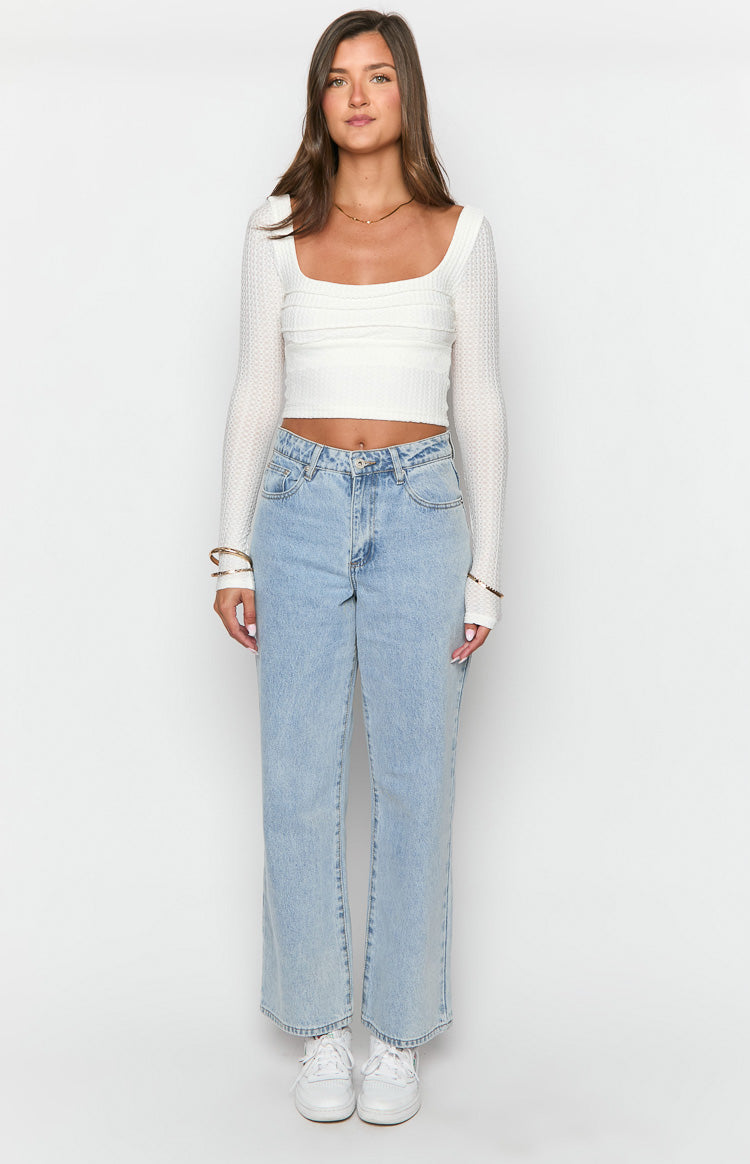 Full front view of light wash mid rise slouchy jeans with a wide leg and relaxed fit