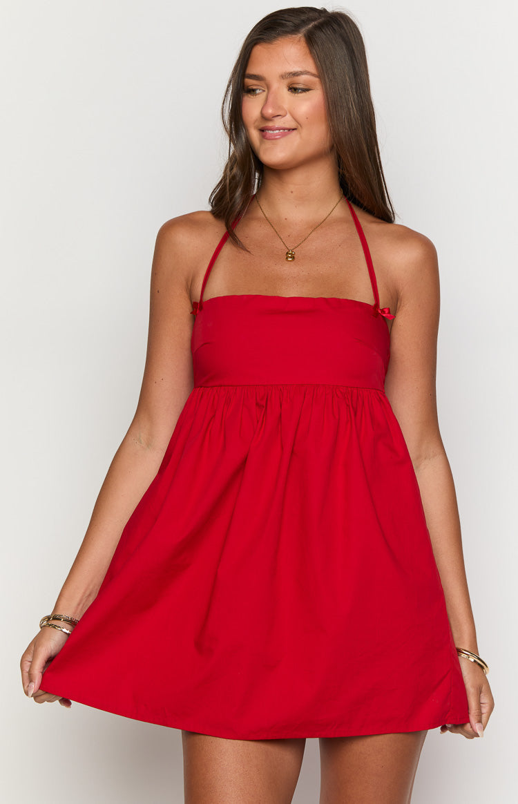 Front view of a red halter mini dress with a square neckline, thin straps, small bows on the bodice, and a gathered full skirt