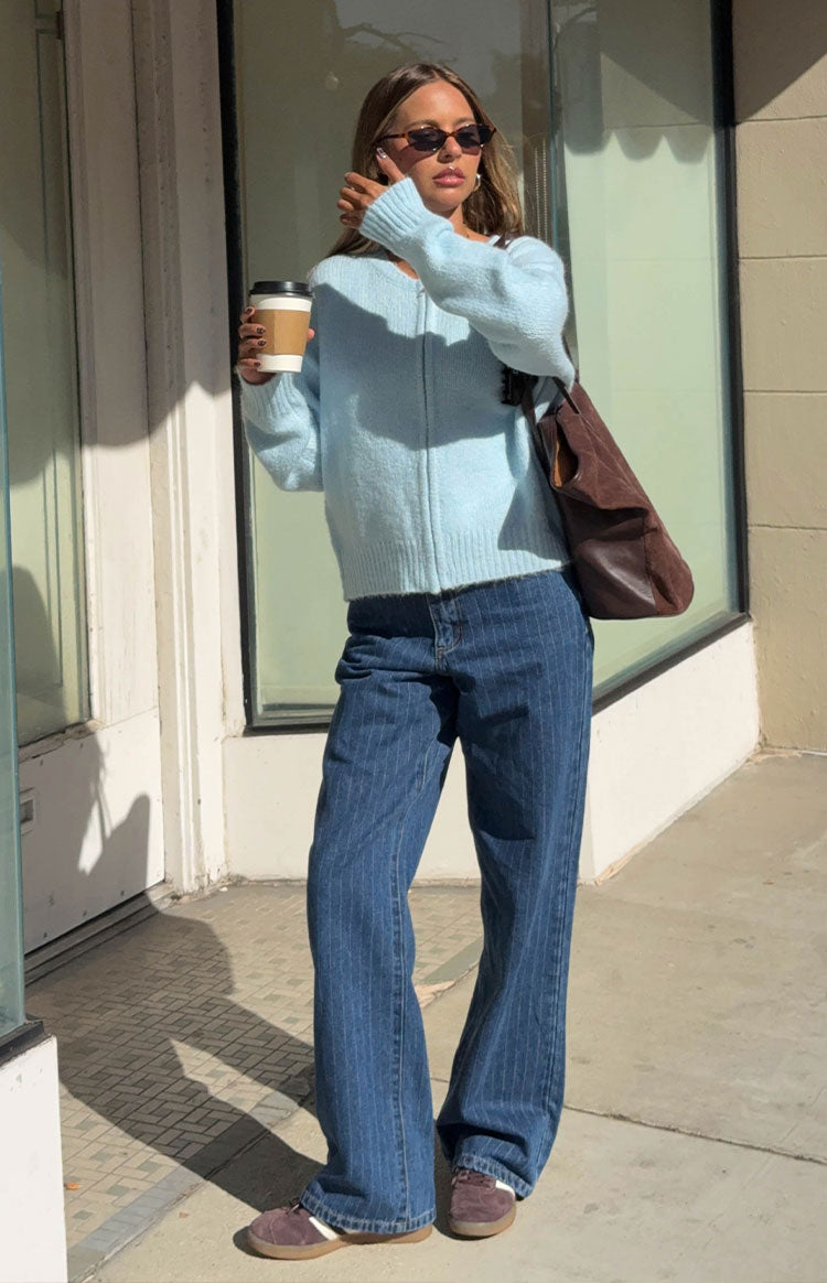 Front view of mid-wash blue pinstripe slouchy jeans with a mid-rise waist and wide leg