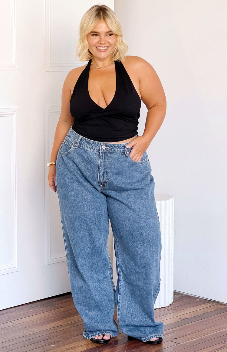 Front view of mid-wash blue mid-rise slouchy jeans with a wide leg and visible front pockets