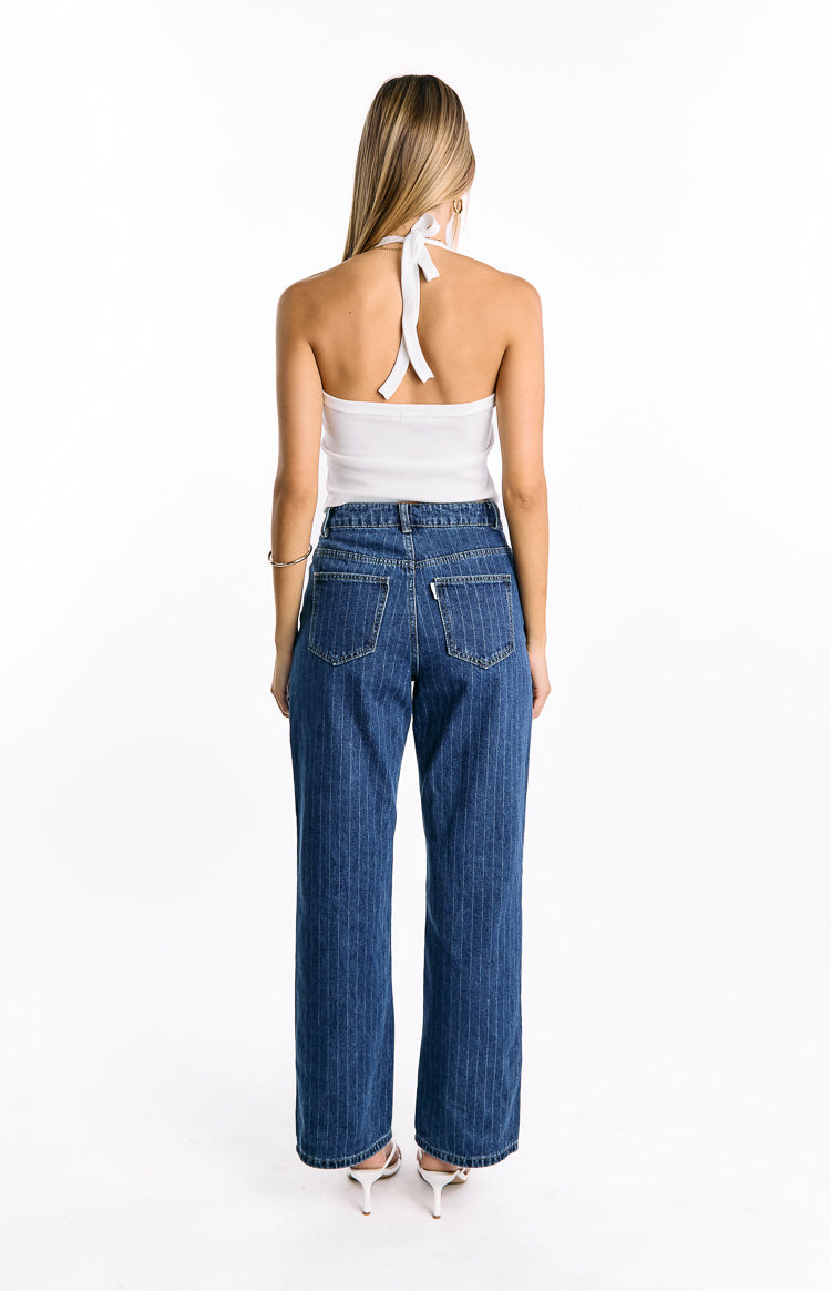 Rear view of mid wash pinstripe slouchy jeans with back pockets and a white label