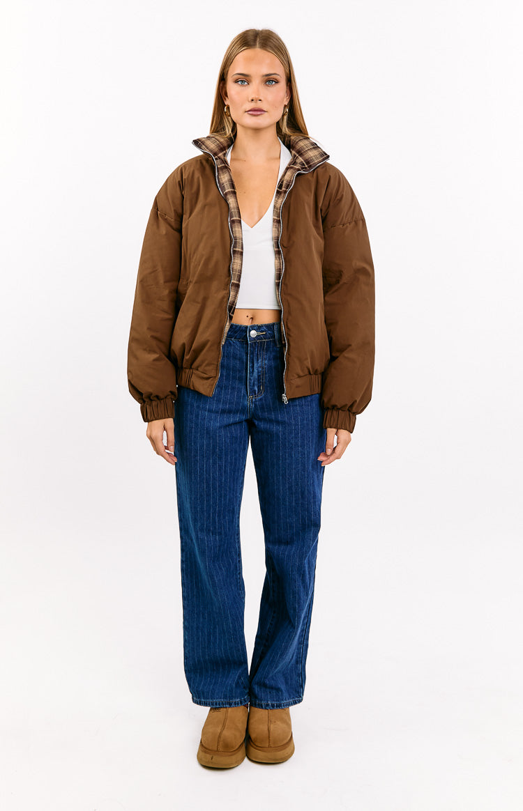 Full front view of mid-wash blue denim slouchy jeans with vertical pinstripes and a mid-rise wide-leg fit