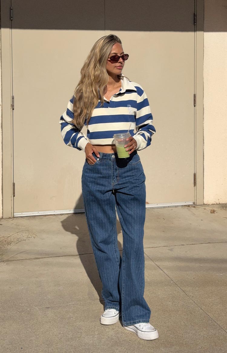 Front view of a blue and white striped cropped jersey with a white collar, long sleeves, and relaxed fit