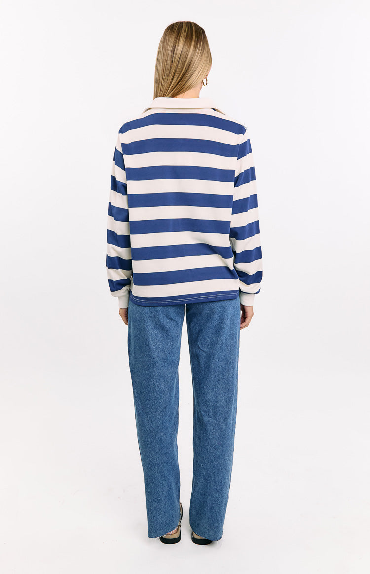 Rear view of a blue and white striped jersey with a collared neckline and ribbed cuffs