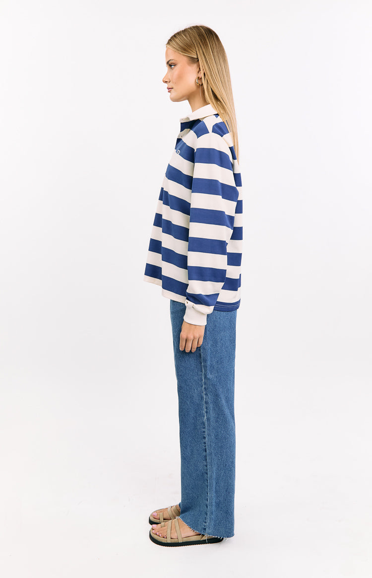 Side view of a blue and white striped jersey with long sleeves and a collared neckline
