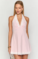 Blonde model wearing a pink halter mini dress with white lace details