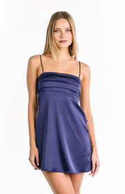 Front view of a navy satin mini dress with a square neckline, thin spaghetti straps, and horizontal tucks on the bodice
