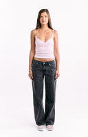 The back view of dark wash denim jeans featuring large white star patches on the back pockets.