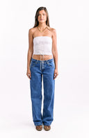 A pair of medium blue wash denim jeans with a low-rise waist and a relaxed wide-leg fit.